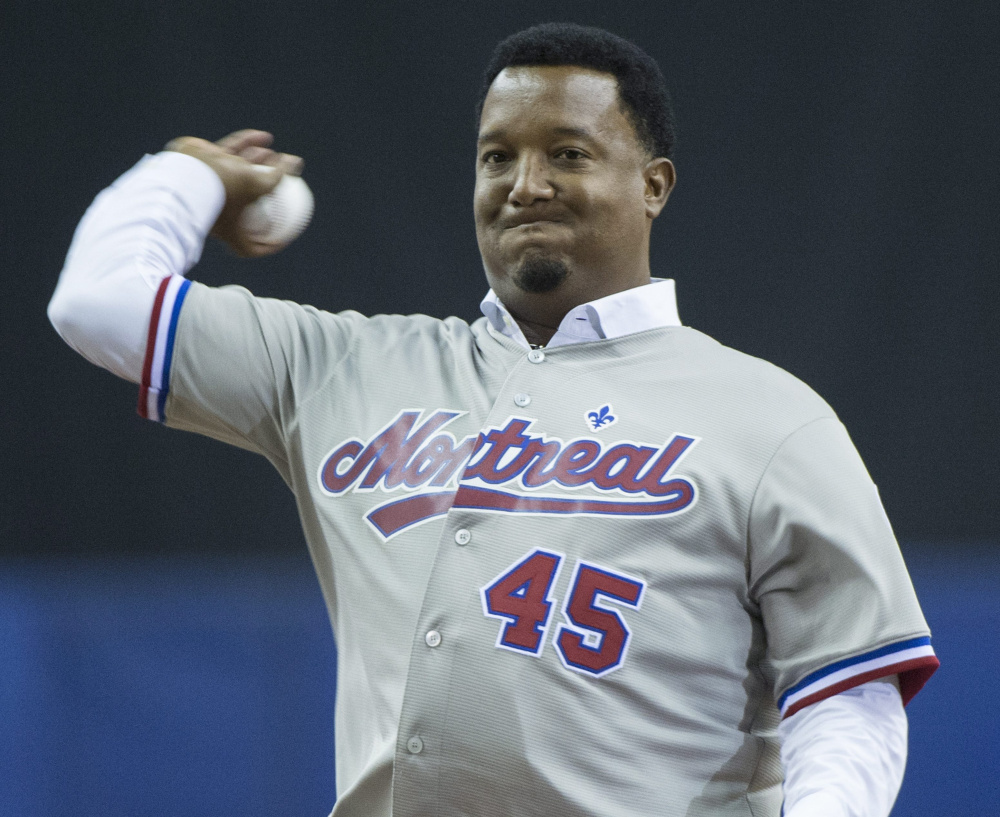 Pedro Martinez, who once pitched for the Montreal Expos, throws out the first pitch Friday night before the Boston Red Sox beat the Toronto Blue Jays 4-2 in 10 innings at Montreal.