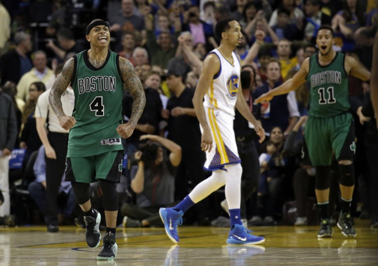 The Celtics' Isaiah Thomas and Evan Turner celebrate as time expires in Friday night's game, a 109-106 win for Boston that ended the Warriors' NBA-record 54-game home winning streak.
The Associated Press