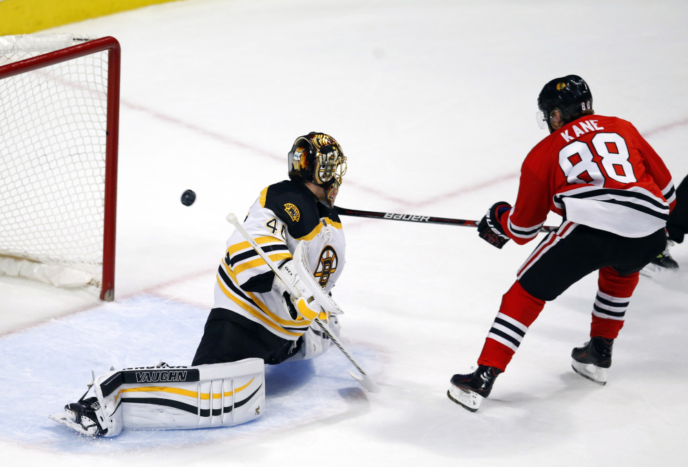 The Associated Press
Chicago's Patrick Kane scores past Boston's Tuukka Rask during the Blackhawks 6-4 win Saturday in Chicago. Kane finished with three goals and an assist.