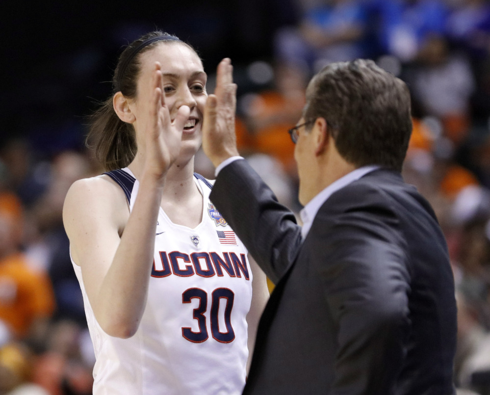 UConn's Breanna Stewart, left, high fives Coach Geno Auriemma during the Huskies' 80-51 win over Oregon State in the Final Four on Sunday in Indianapolis.