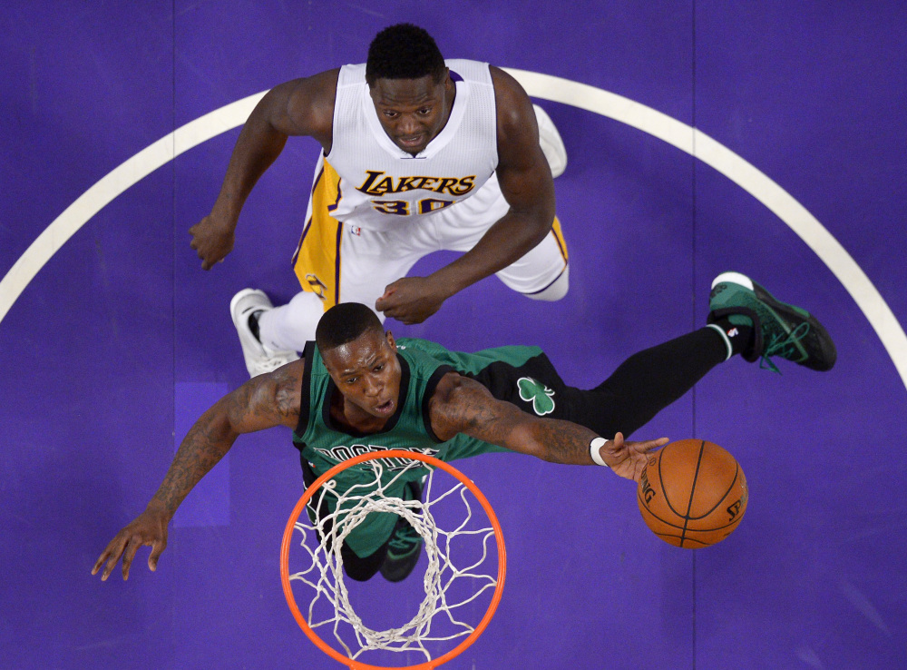 Celtics guard Terry Rozier, below, shoots while being defended by Lakers forward Julius Randle defends during the first half of the Celtics' 107-100 win Sunday in Los Angeles.