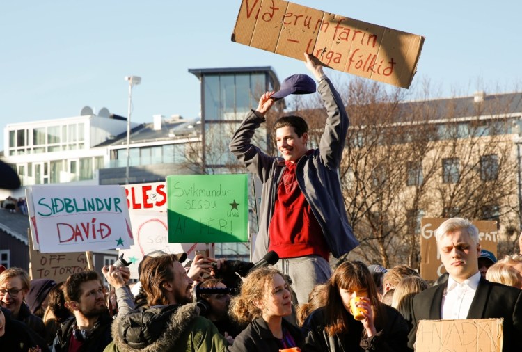 Demonstrators denounce Iceland's prime minister Monday in Reykjavik after a media investigation linked him to an offshore company and a potential a conflict of interest.