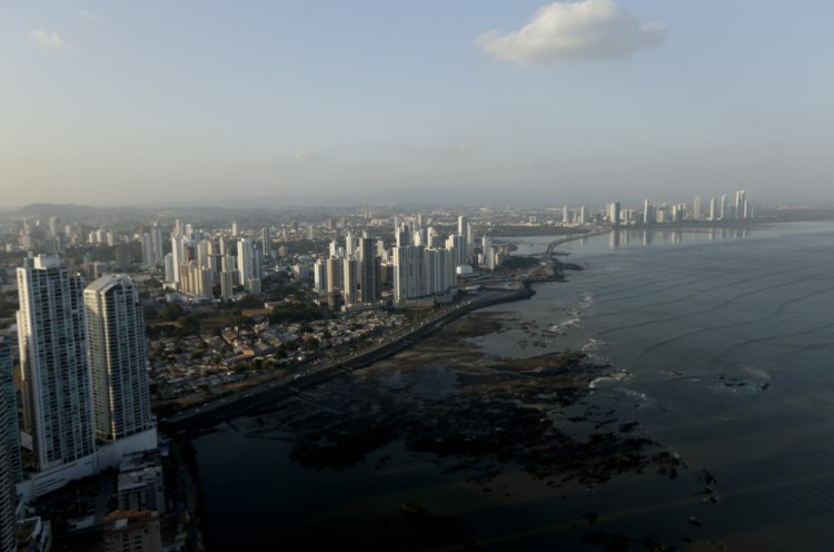 The setting sun lights up the Panama City skyline, Monday.