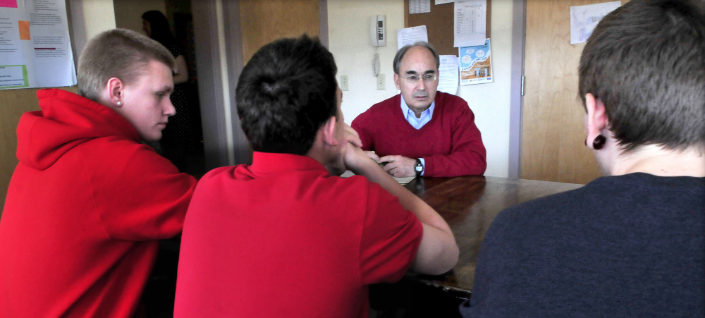 U.S. Rep. Bruce Poliquin, a Republican from Maine's 2nd District, listens to students including Kyle Hendrickson, left, on Tuesday during a tour of the Day One residential substance abuse center on the Good Will-Hinckley campus in Fairfield.