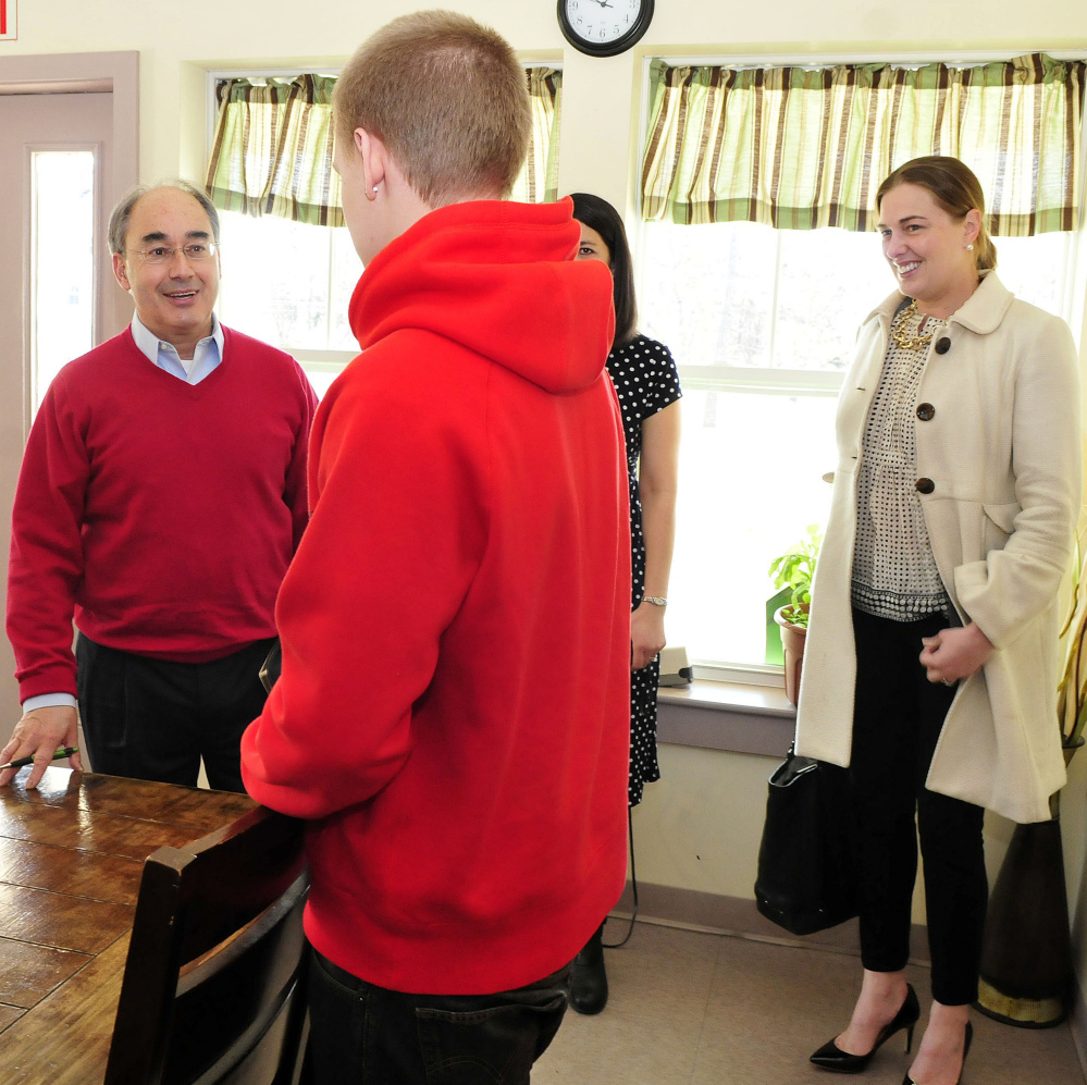 U.S. Representative Bruce Poliquin, R-2nd District, is greeted by student Kyle Hendrickson on Tuesday during a tour of the Day One residential substance abuse center in Fairfield. At right is board member Samantha Warren.