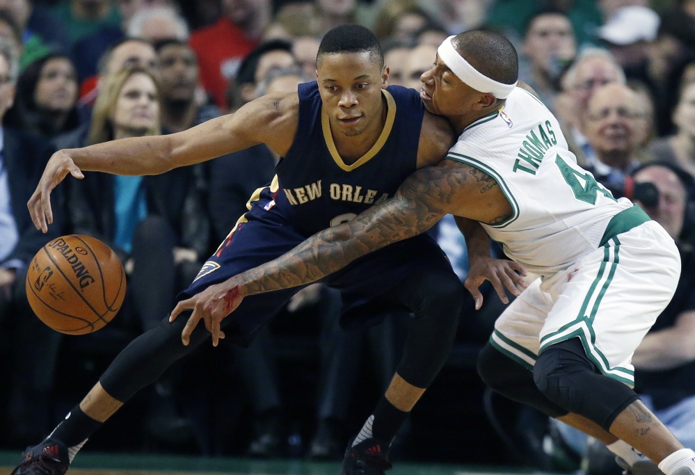 Boston's Isaiah Thomas reaches in on New Orleans' Tim Frazier, a former star for the Maine Red Claws, in the first quarter of Wednesday night's game at Boston. Frazier had 18 points and six assists.