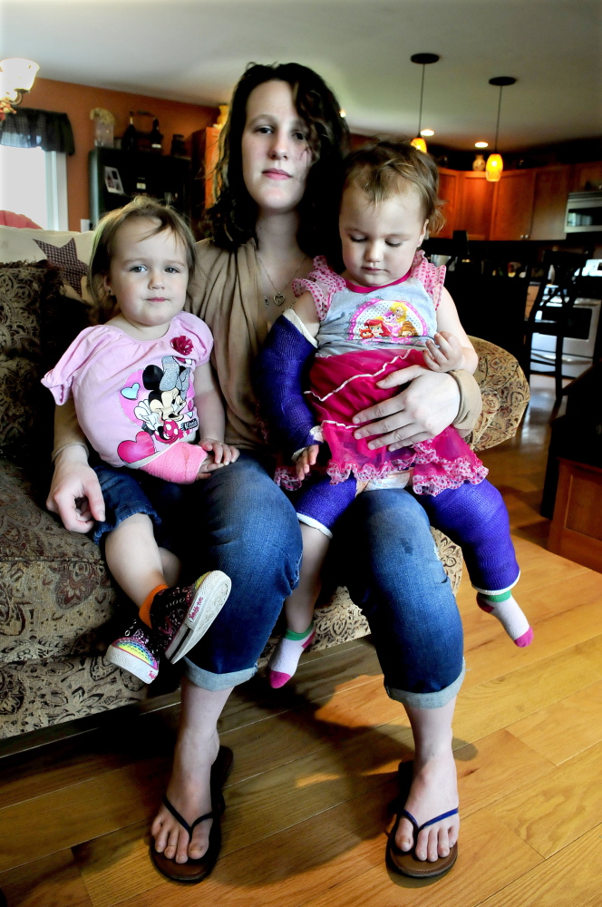Emily Walker holds her twin daughters, Maddilyn, left, and Brooklyn, who were 2 at the time, weeks after they were attacked in their Oakland home.