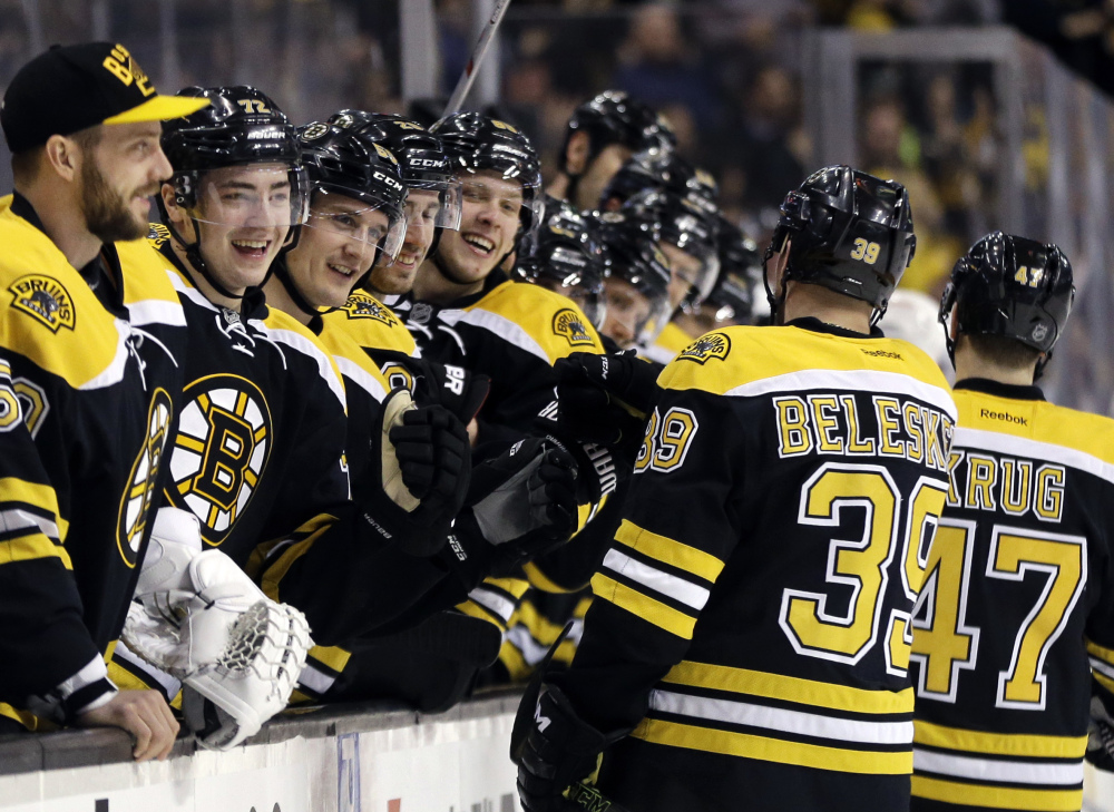 The Bruins' bench greets Bruins defenseman Torey Krug, 47, and left wing Matt Beleskey after Krug's goal against the Detroit Red Wings in the second period Thursday night in Boston. The Bruins won 5-2.