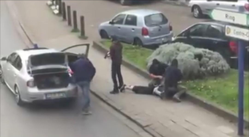 In this image made from video, police arrest a man in the Anderlecht area of Brussels on Friday.
