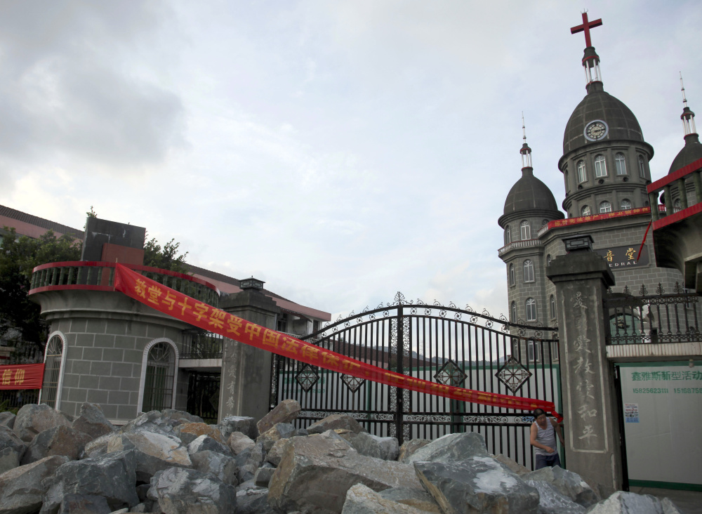 Members of a Christian church in Zengshan Village  piled up rocks at the front gate to prevent government workers demolishing their church's  cross in 2014. China has long had an uneasy relationship with Christianity, with the crosses targeted for building code violations.