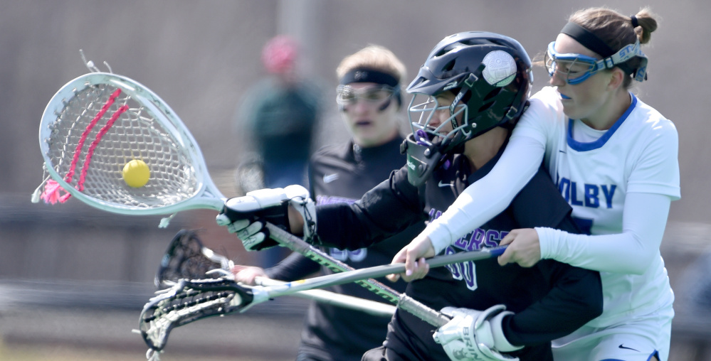 Colby's Grace McVey, right, battles for the ball with Amherst goalie Christy Forrest during a New England Small College Athletic Conference women's lacrosse game Saturday in Waterville. Amherst won, 8-4.