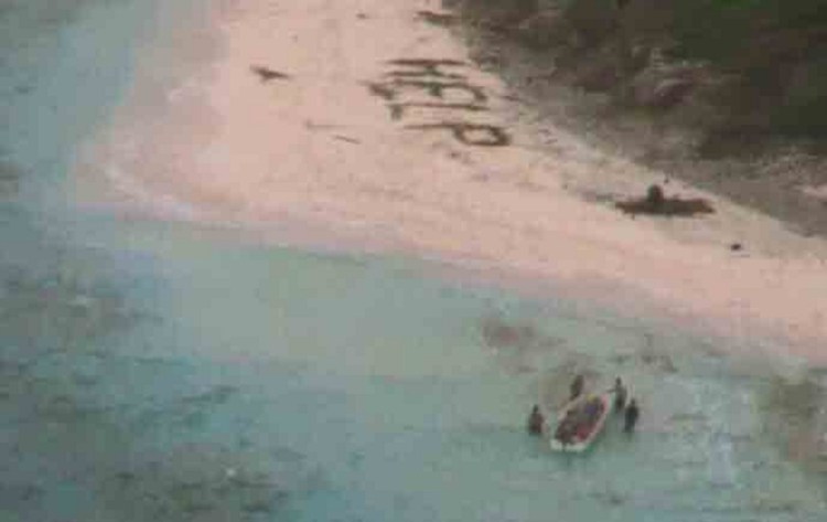 A boat picks up three men stranded on a remote Pacific island after U.S. Navy fliers spotted their palm-leaf message.