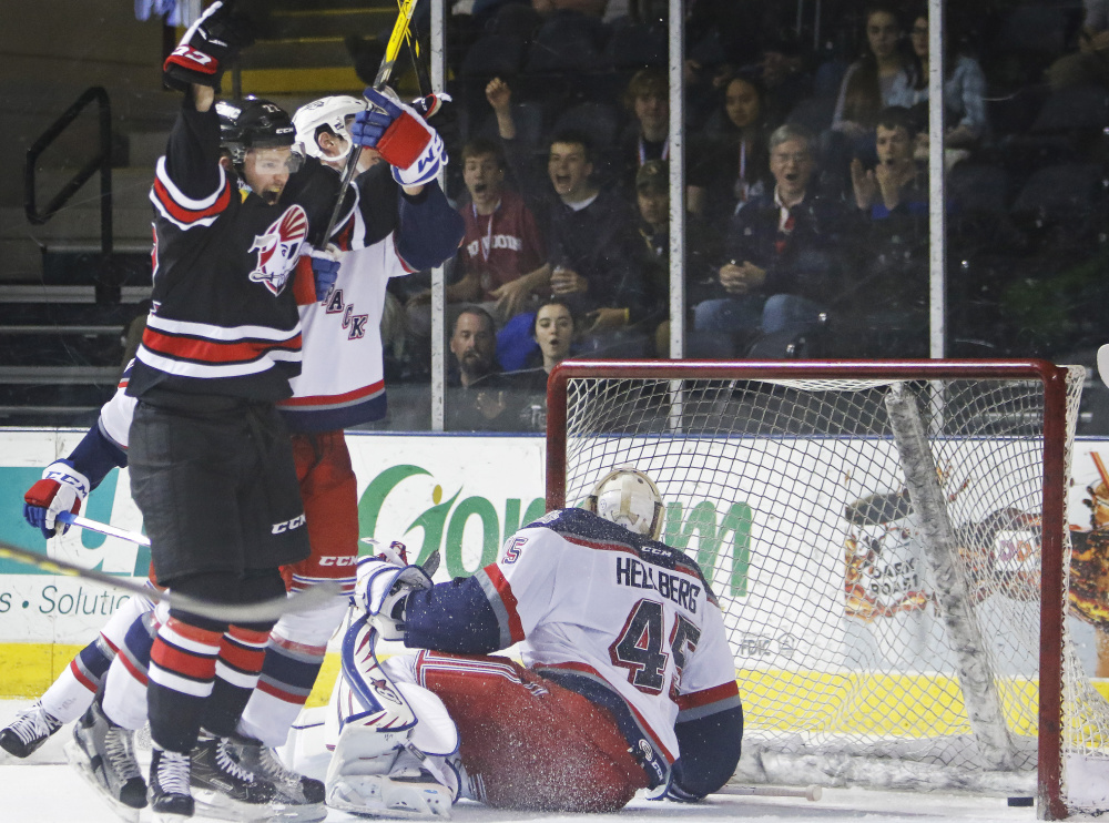 Logan Shaw celebrates one of his two goals Sunday during the Pirates' 3-2 win over the Hartford Wolf Pack at Cross Insurance Arena.