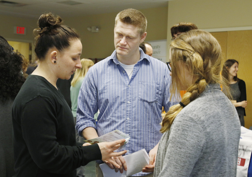 Donald James, an ex-worker at Merrymeeting Behavioral Health Services, talks with Erica Higginbotham, left, and Brooke Dunham about jobs at MAS Community Health.