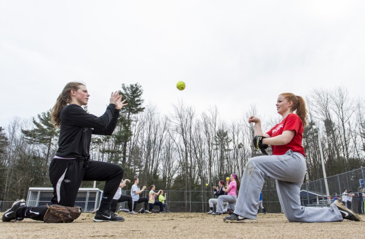 Yarmouth seniors Colleen Sullivan and Mari Cooper work on a throwing drill during a preseason practice. Both helped the Clippers win their first state title last spring.