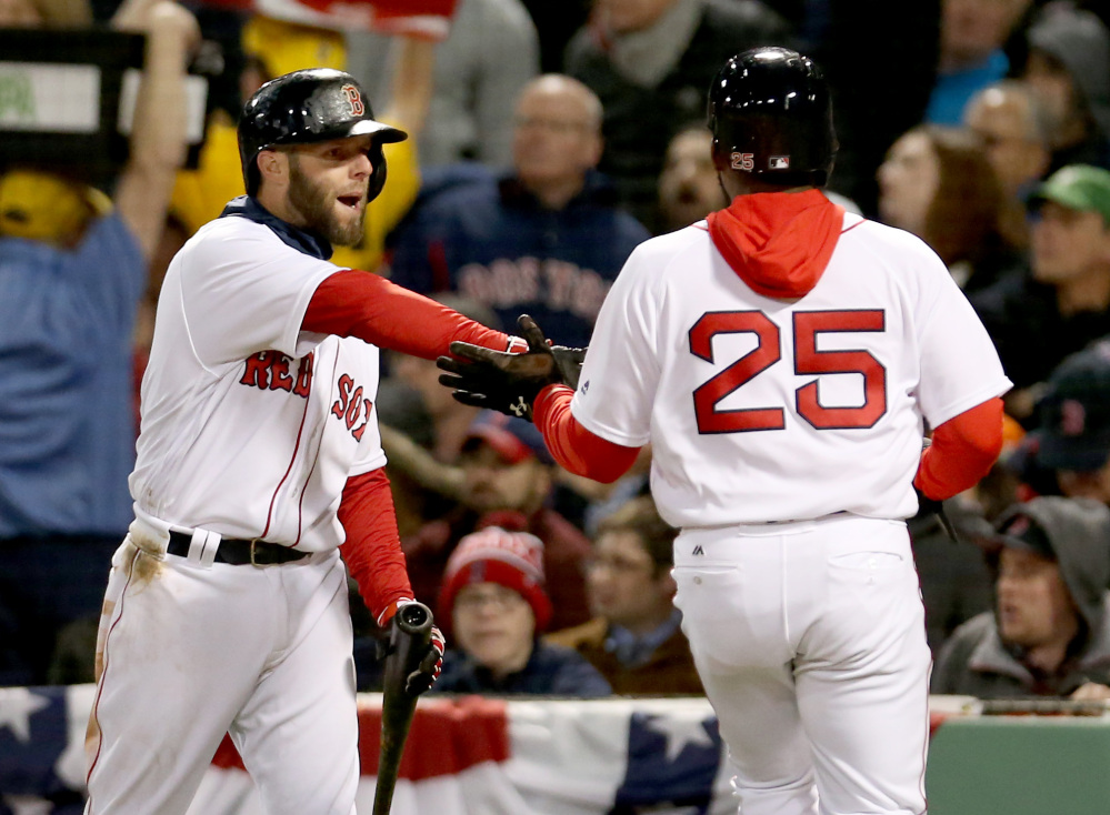 Boston's Jackie Bradley Jr. is congratulated by Dustin Pedroia after scoring on a groundout by Mookie Betts in the fourth inning Wednesday night in Boston.