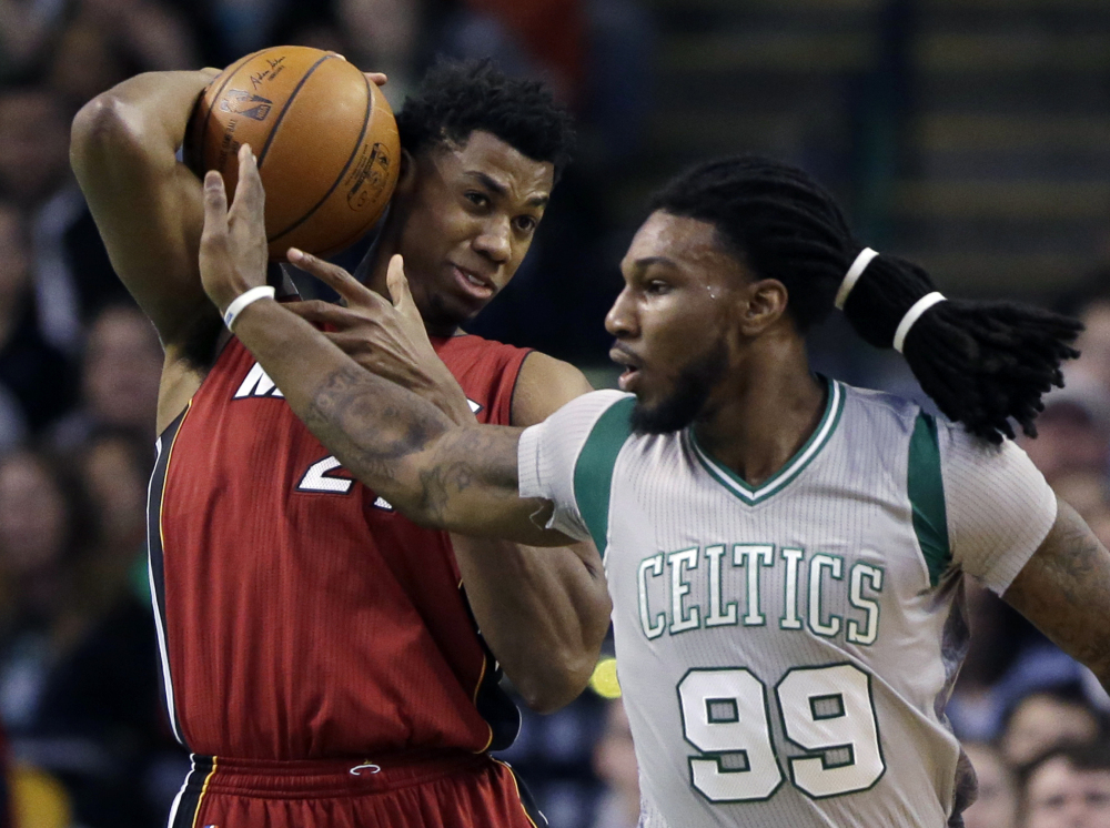 Miami center Hassan Whiteside pulls down a defensive rebound in front of Boston's Jae Crowder in the first quarter Wednesday night in Boston.