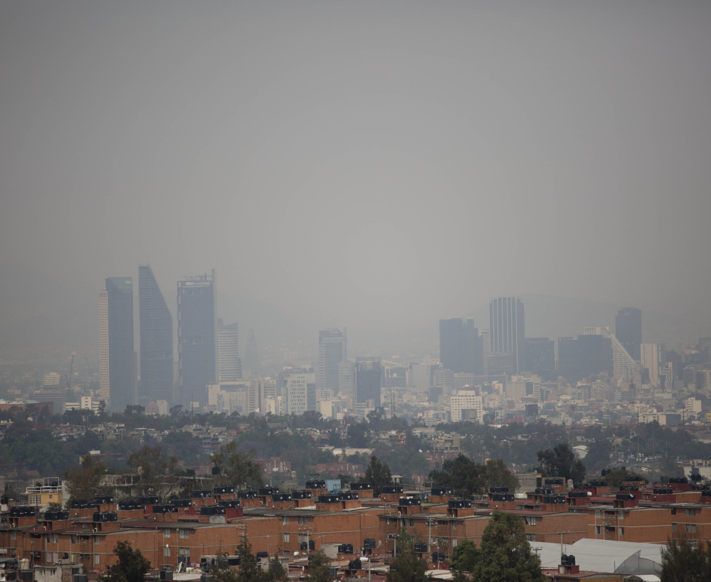 Air pollution hangs over Mexico City earlier this year. Smog in the capital got so bad last week that city officials banned 40 percent of all vehicles from the streets.