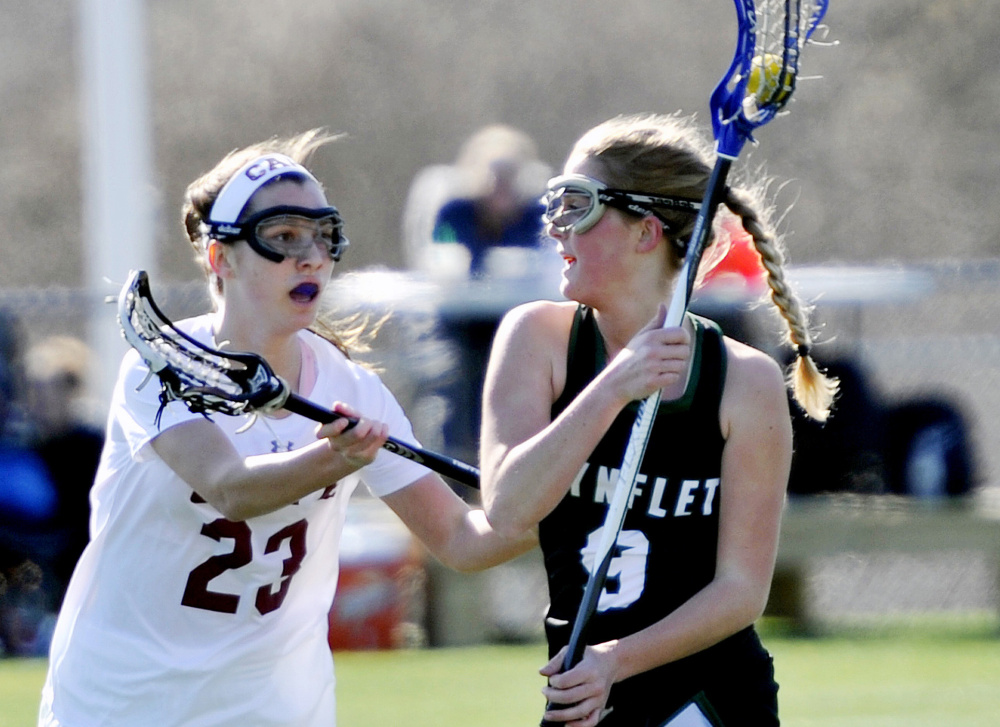Nina Moore of Waynflete, right, drives with the ball as Eleanor Roberts of Cape Elizabeth defends Thursday in their girls' lacrosse game on the opening day of spring sports in Maine. Waynflete won 8-7 in overtime.