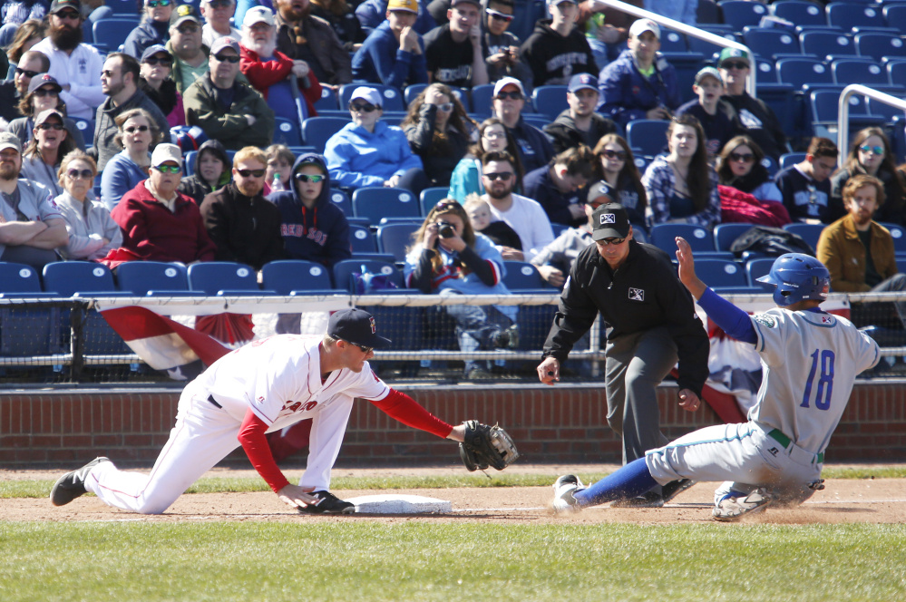 Jantzen Witte of the Portland Sea Dogs reaches to tag out Michael Benjamin of Hartford, who was attempting to steal third base in seventh inning during Saturday's game at Hadlock Field. Hartford won the game, 6-2.