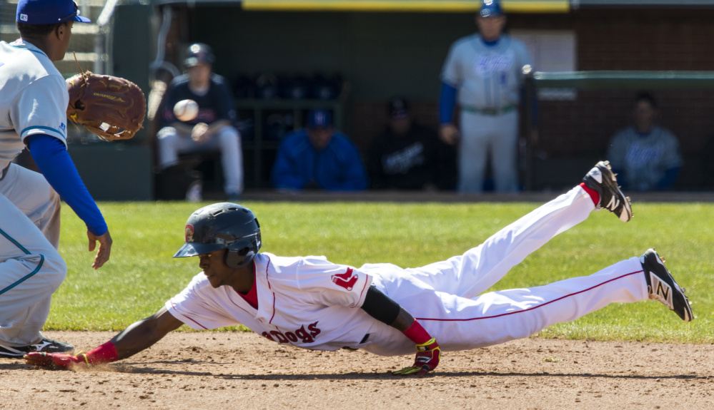 Jose Vinicio of the Sea Dogs dives safely back to first base on a pickoff attempt Sunday as Hartford Yard Goats first baseman Correlle Prime fields the throw. The Sea Dogs lost, 8-1.