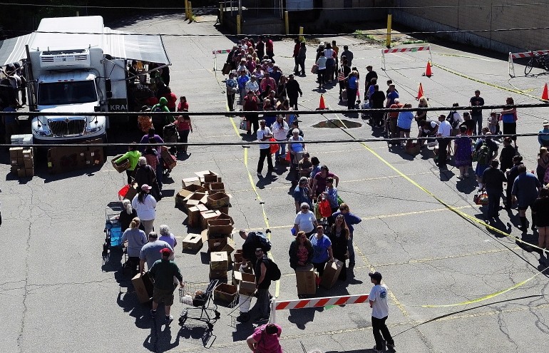 A line snakes through the Augusta parking lot where a Good Shepherd Food Mobile event took place in 2014. Food insecurity is one of the issues in Maine that Gov. LePage has ignored as he's pursued partisan goals.