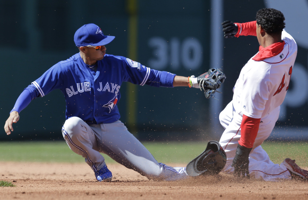 Marco Hernandez steals second base as Blue Jays second baseman Ryan Goins, left, is unable to handle the throw. Hernandez started at second base and got his first major-league hit, but the Red Sox lost, 5-3.