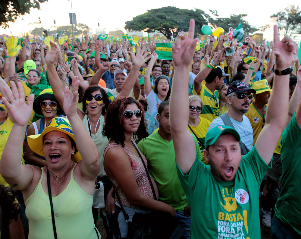 Demonstrators watch a live broadcast of lawmakers voting on whether or not to impeach Brazil's President Dilma Rousseff in Brasilia, Brazil, on Sunday.