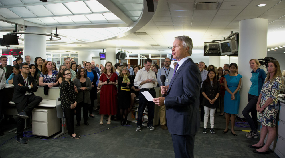 Gary Pruitt, president and CEO of The Associated Press, addresses company employees in the New York newsroom as AP wins the Pulitzer Prize for public service Monday in New York. AP journalists Margie Mason, Robin McDowell, Martha Mendoza and Esther Htusan documented the use of slave labor in Southeast Asia to supply seafood to American tables, an investigation that spurred the release of more than 2,000 captive workers.