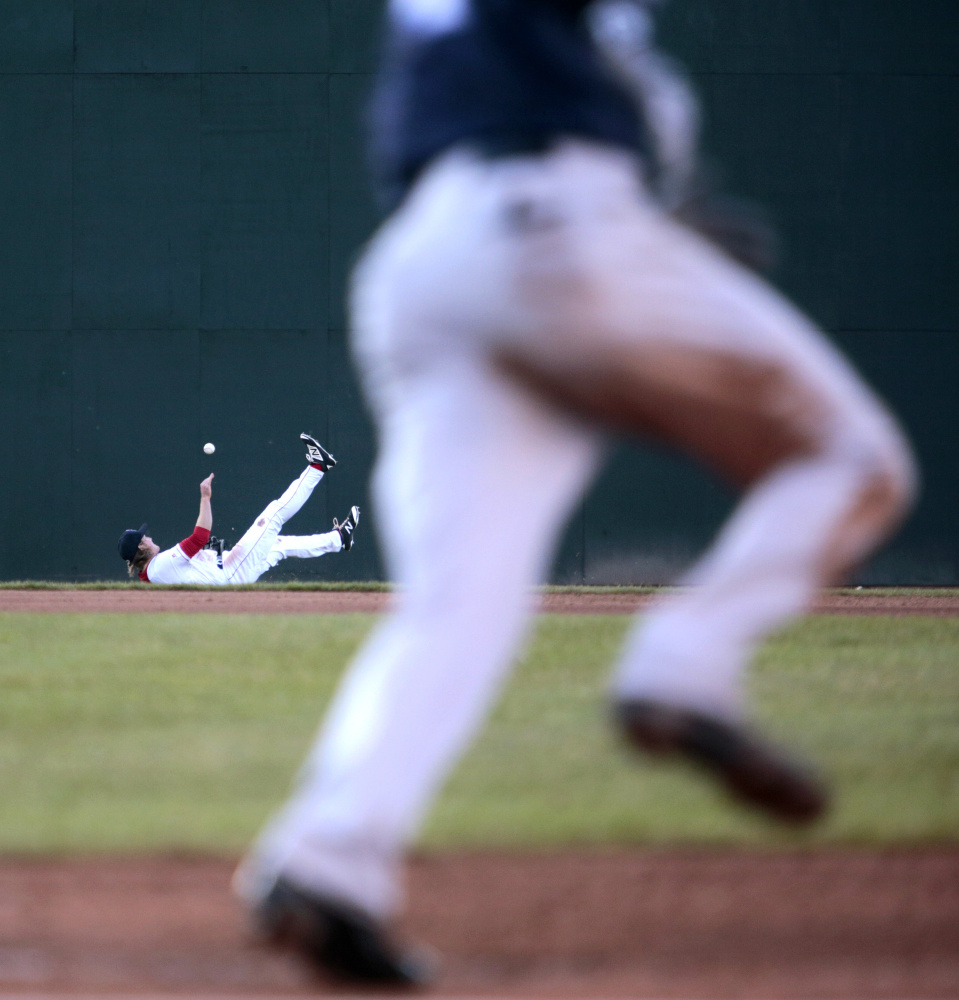 Derek Davis/Staff Photographer
Derek Miller of Portland dives but can't come up with a shallow ball hit to left field by Tyler Wade of Trenton resulting in a double in the fourth inning.