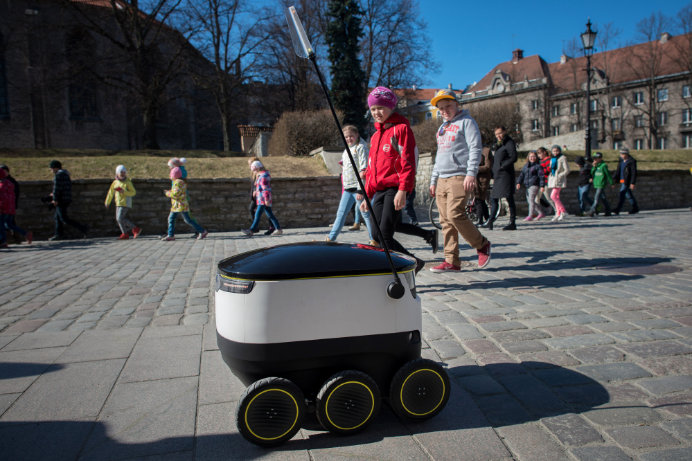 Schoolchildren watch a prototype robot developed by Starship Technologies pass by in Tallinn, Estonia, this month. Their use in e-commerce delivery is expected later this year.