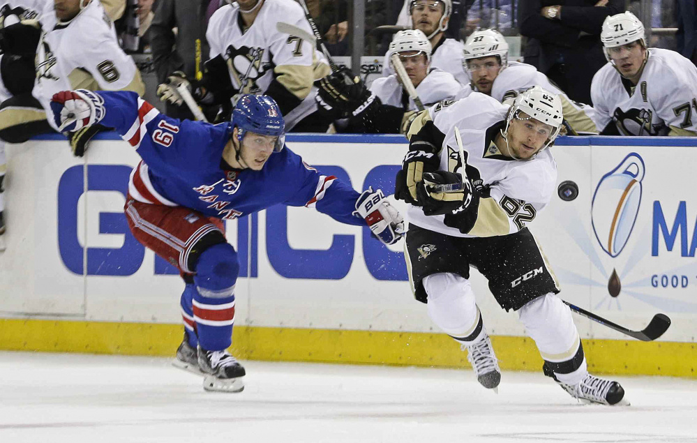 Jesper Fast of the Rangers chases Pittsburgh's Carl Hagelin in the first period Tuesday night in New York. The Penguins scored two third-period goals for a 3-1 win and a 2-1 lead in the series.
