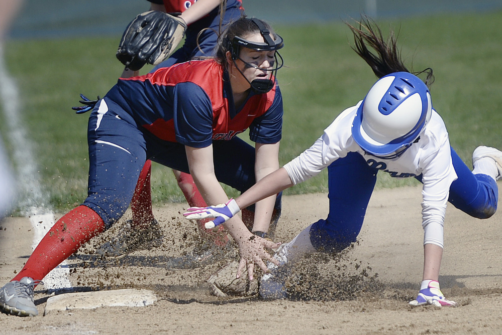 Third baseman Grace Kariotis blocks the bag and tags out Malori Cole of Kennebunk during their Western Maine Conference softball game Wednesday. Gray-New Gloucester won, 15-5.