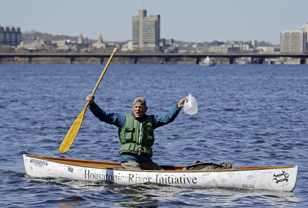 Denny Alsop, 69, of Stockbridge, Mass., celebrates on the Charles River as he finishes his monthlong paddle on Wednesday to highlight the need for clean water. He also drew attention to General Electric's resistance to the EPA's proposed Housatonic River cleanup.