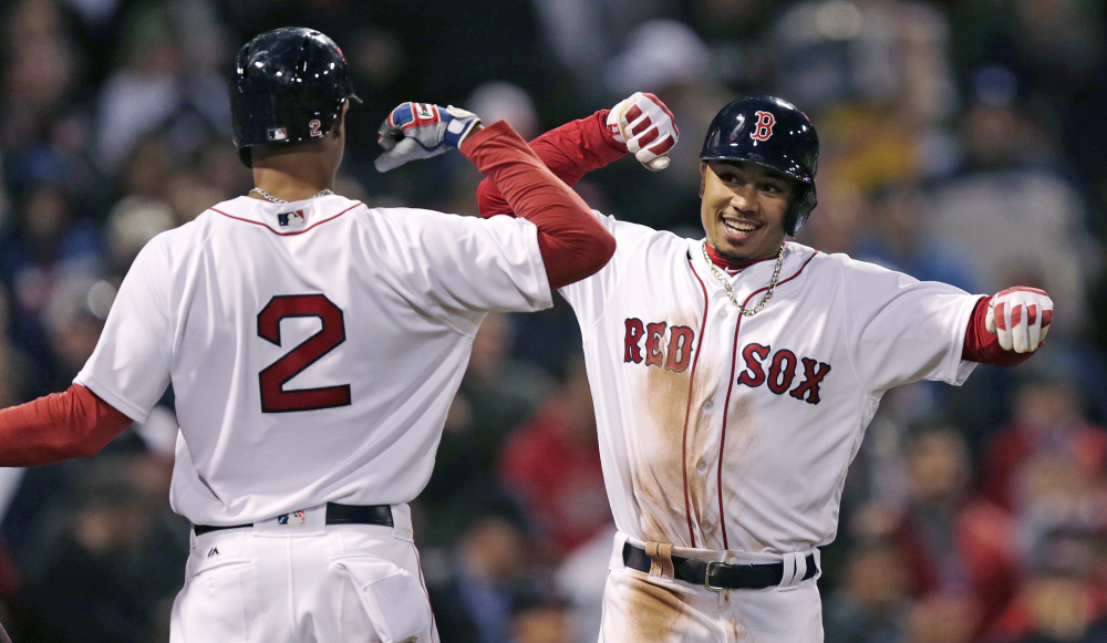 Boston's Mookie Betts, right, is congratulated by Xander Bogaerts after his two-run home run in the second inning Wednesday night against the Tampa Bay Rays at Boston.