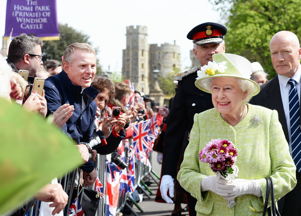 Queen Elizabeth II greets well-wishers during a 30-minute walkabout near Windsor Castle as she celebrates her 90th birthday Thursday in Windsor, 20 miles west of London.