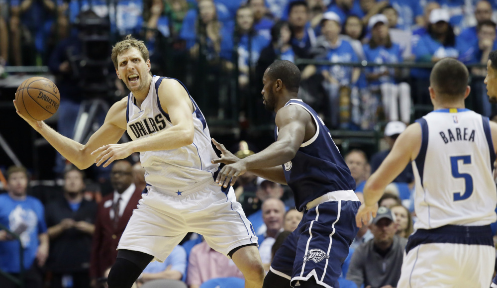 Dallas Mavericks forward Dirk Nowitzki (41) looks to pass against Oklahoma City Thunder forward Serge Ibaka (9) during the first half in Game 3 of a first-round NBA basketball playoff series Thursday, April 21, 2016, in Dallas. (AP Photo/LM Otero)