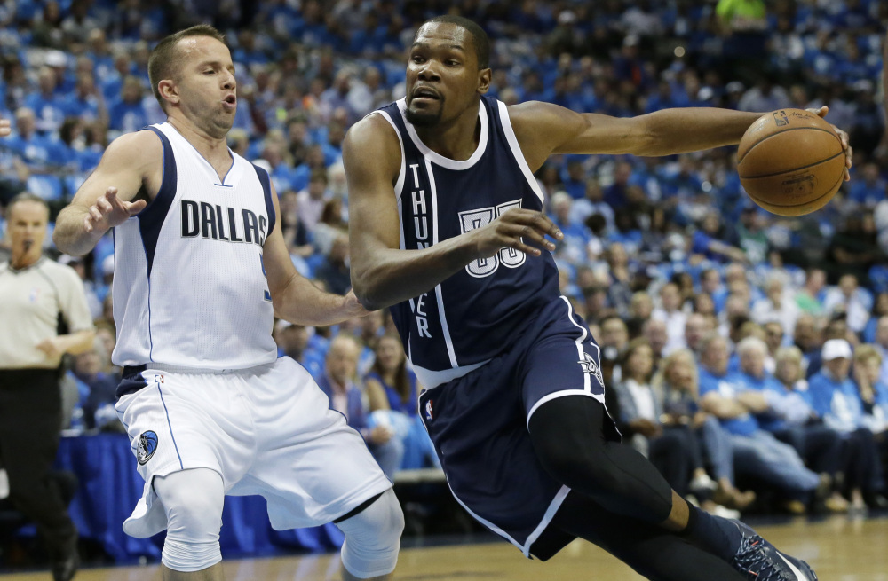 Oklahoma City forward Kevin Durant drives against Dallas Mavericks guard J.J. Barea during the first half of Game 3 on Thursday night, won 131-102 by the Thunder.
