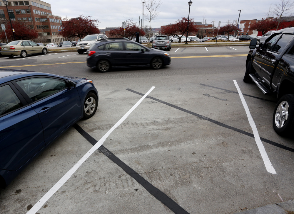The lines of "pay to park" spots on Spring Street have gone wrong in several ways since the spots' creation in December 2015. (Photo by Derek Davis/Staff Photographer)