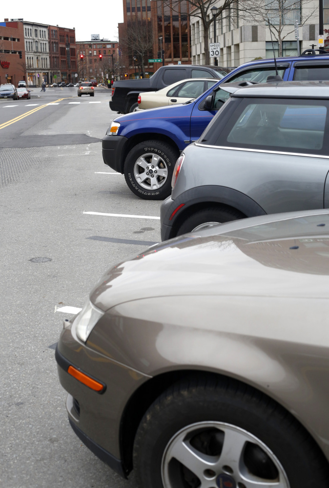 Drivers have been confused by the back-in angled parking on Spring Street, as evidenced by this row of cars.  (Photo by Derek Davis/Staff Photographer)