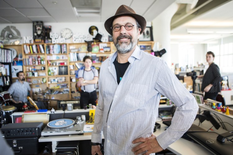 Bob Boilen, host of the "Tiny Desk Concerts" series, pauses during a sound check for the artist Monika at his NPR desk in Washington.