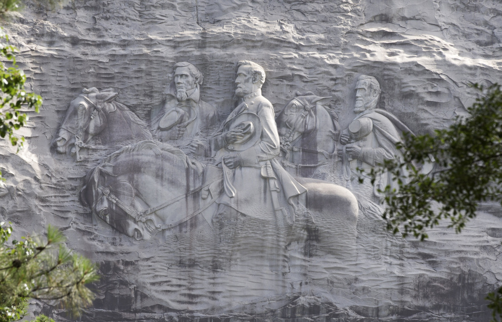 A carving of Stonewall Jackson, Robert E. Lee and Jefferson Davis adorns Stone Mountain in Georgia, where a white power rally Saturday resulted in nine arrests.