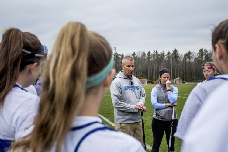 Kennebunk athletic director Joe Schwartzman, center left, runs the junior varsity girls' lacrosse team during Friday's practice, with help from assistant coach Lauren MacPherson, center right. As the number of athletic programs has risen dramatically, Schwartzman exemplifies the difficulties school officials face trying to find applicants for coaching positions.