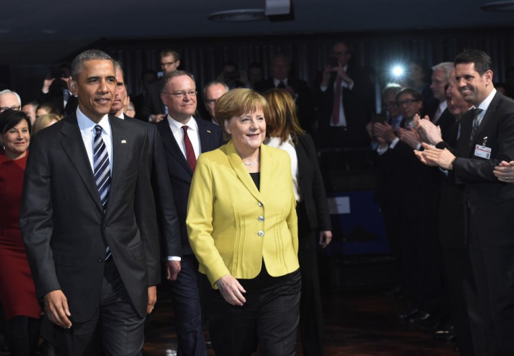 President Obama and German Chancellor Angela Merkel arrive for the opening of the Hannover Messe industry fair in Hannover, northern Germany, on Sunday.