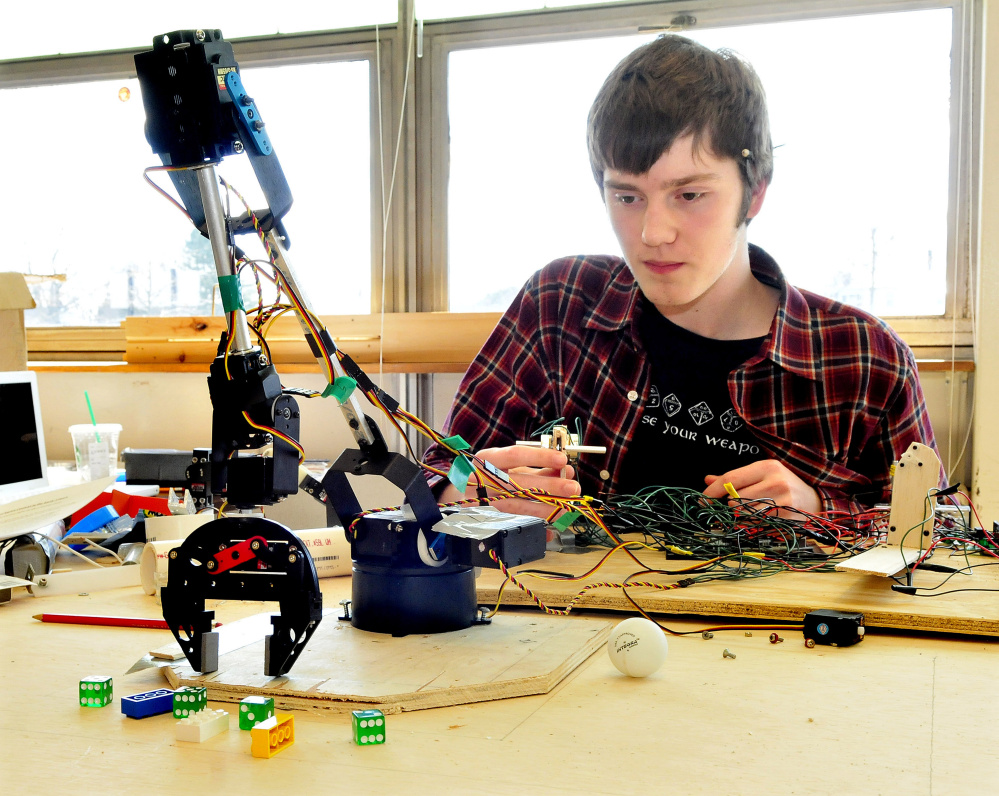 Maxwell Burger-Roy works on a robot arm that he and members of the Waterville Science Olympiad team will compete with in May. The team won the state Science Olympiad for the 17th time in 21 years.