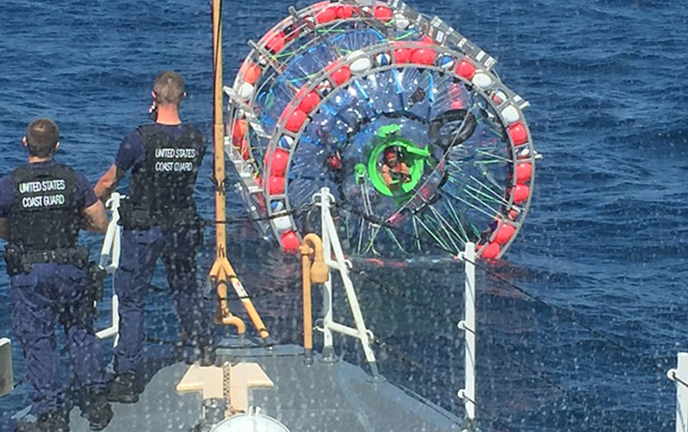 A Coast Guard cutter crew prepares Sunday to pull in Reza Baluchi, who two days earlier embarked from Pompano Beach, Fla., in his "hydro pod" on a 3,500-mile mission. "I wanted to do something unique – show children that anything is possible if you want it," he said.