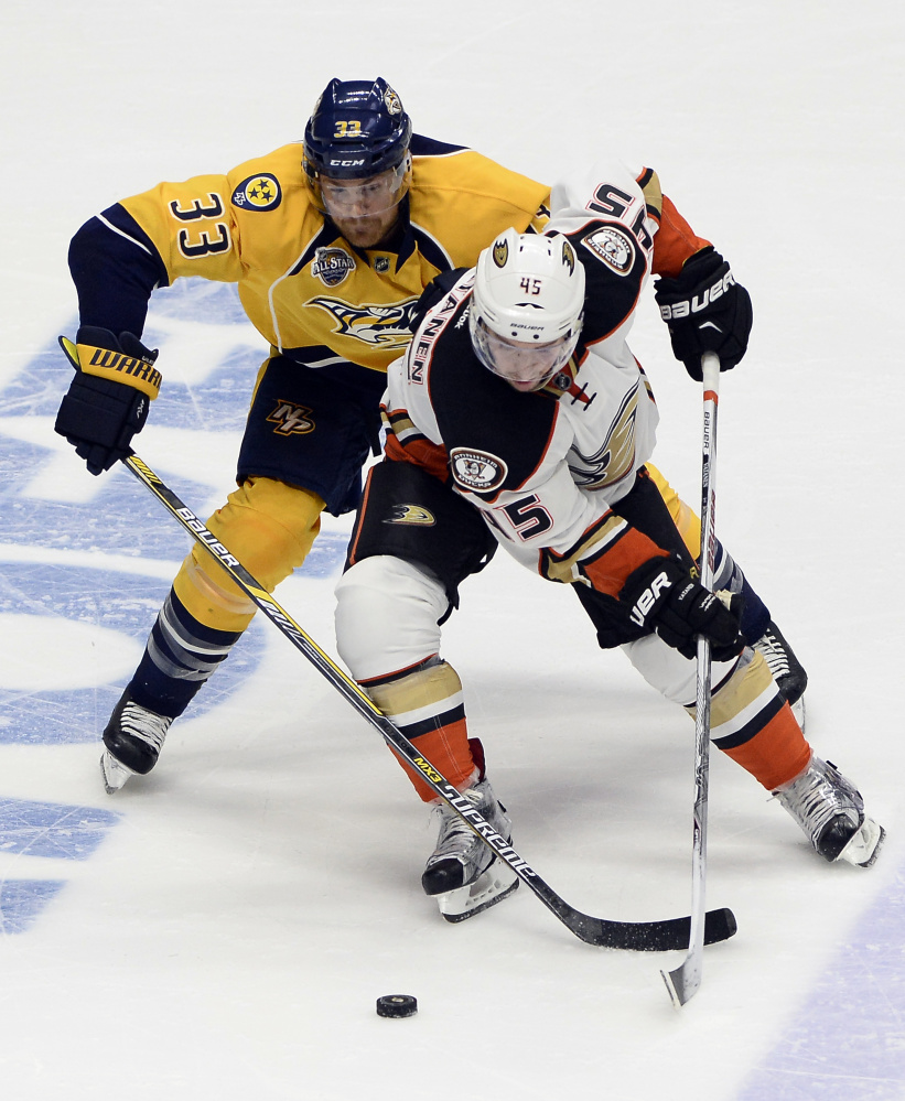 Anaheim defenseman Sami Vatanen, right, controls the puck in front of Nashville's Colin Wilson during the first period of a 3-1 win by the Predators in Game 6 of their first-round Stanley Cup playoff series Monday at Nashville.