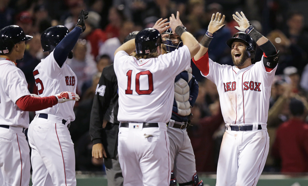 Boston's Dustin Pedroia, right, is congratulated after his grand slam in the second inning Wednesday night at Fenway Park.