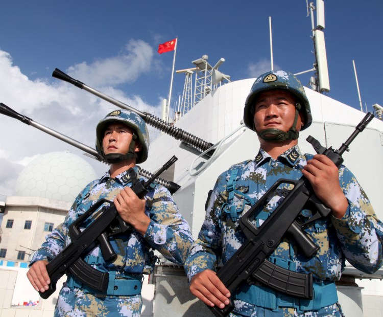 Chinese soldiers stand guard in the Spratly Islands, known in China as the Nansha Islands, on Feb 10. China has built military outposts on the disputed group of 14 islands, islets and more than 100 reefs in the South China Sea.