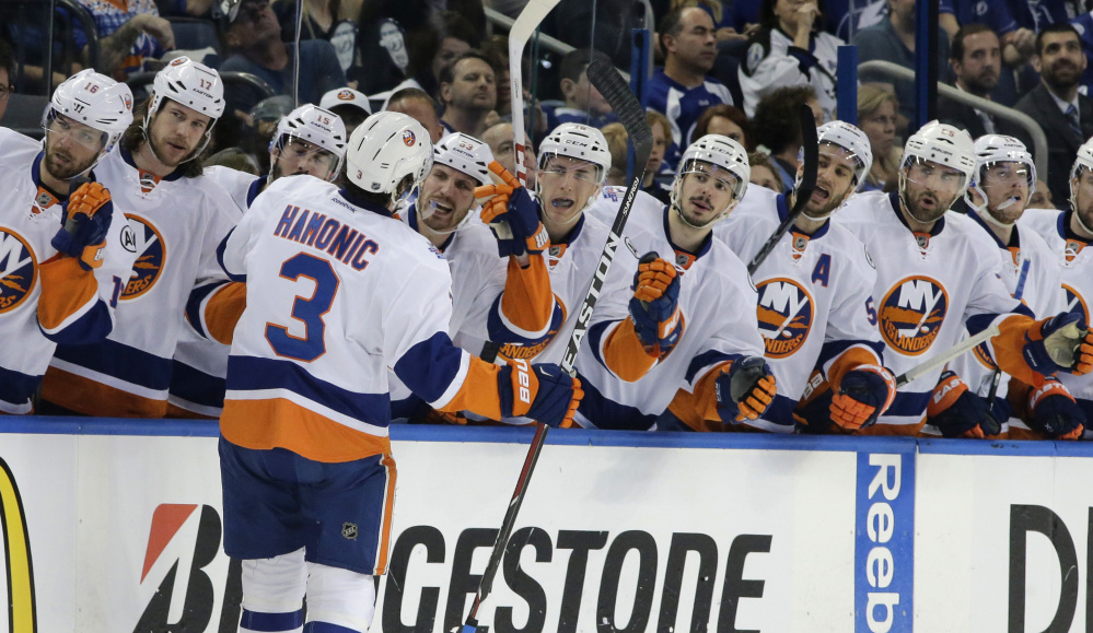 Travis Hamonic of the Islanders is met by his teammates after scoring against Tampa Bay during a 5-3 win in Game 1 of the Eastern Conference semifinals Wednesday at Tampa, Fla.